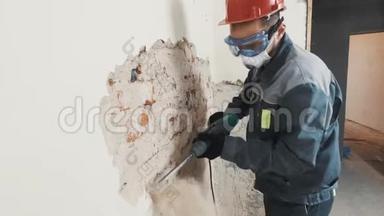 穿防护服的工人拆除石膏墙。 脏，<strong>辛苦</strong>.. 个人防护设备。 头盔、呼吸器